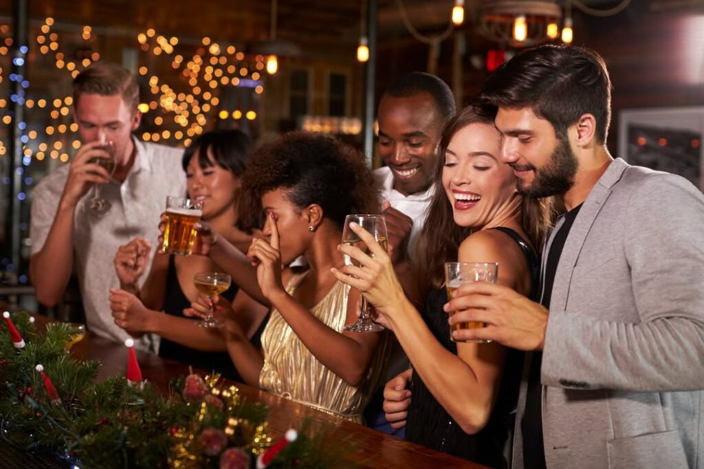 Friends celebrating together at a Christmas party in a bar